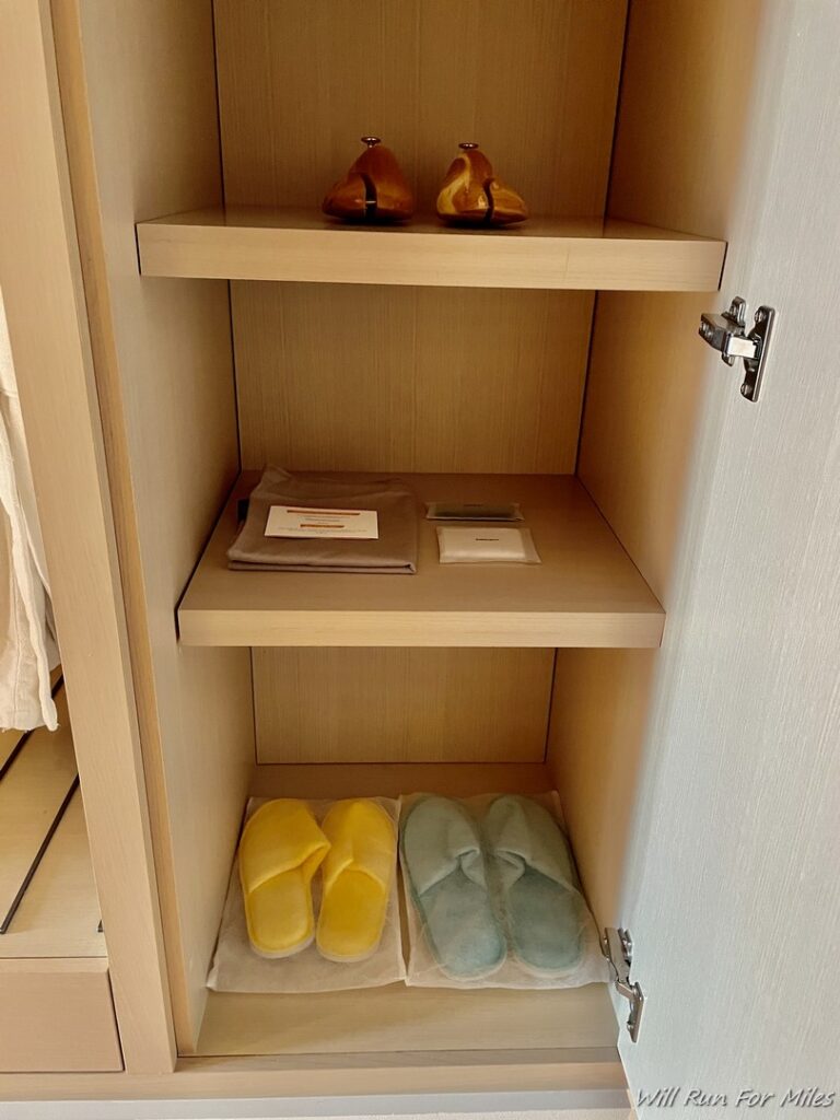 a shelf with slippers and a bird on it
