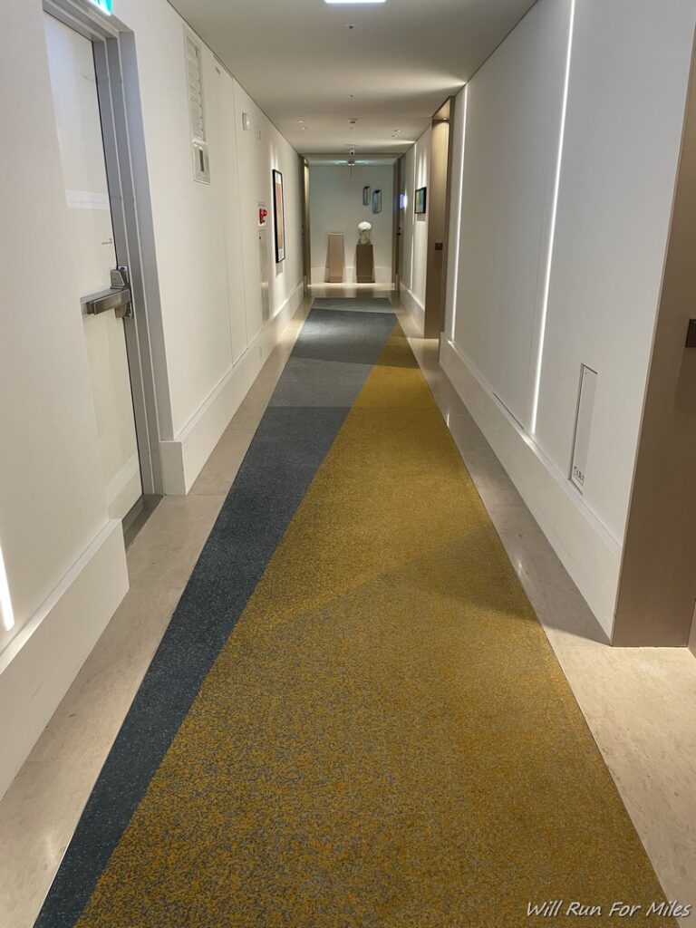 a hallway with a yellow and grey carpet
