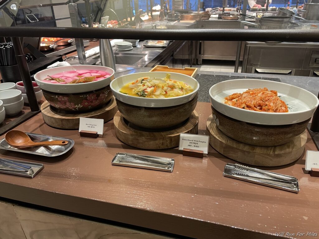 a row of bowls of food on a table