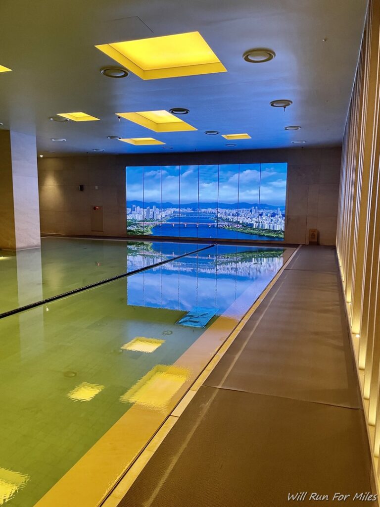 a large indoor swimming pool with a large window