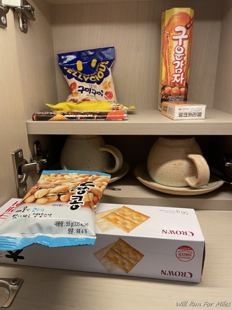 a shelf with snacks and cups