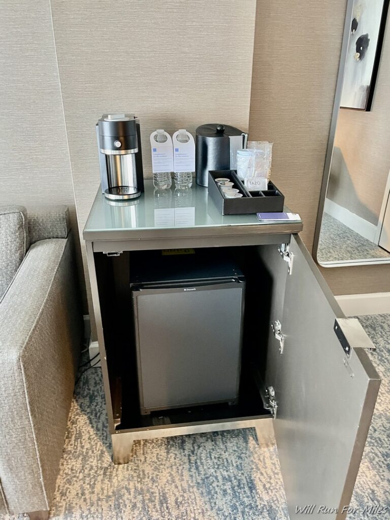 a small table with a small refrigerator and a small refrigerator