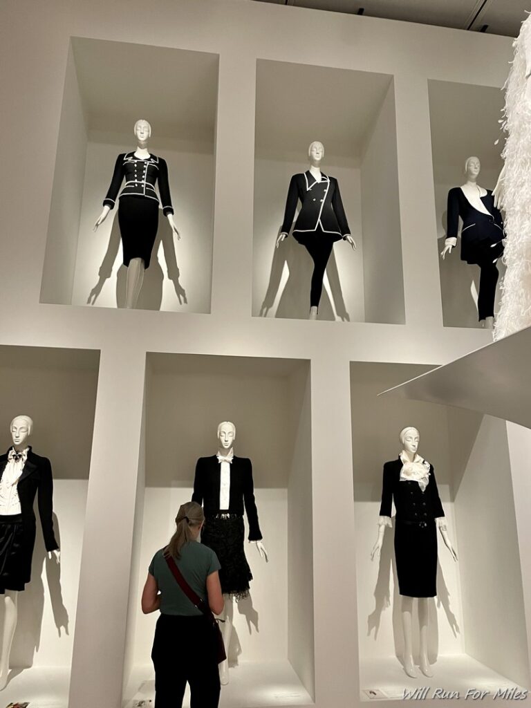 a woman looking at mannequins in a store