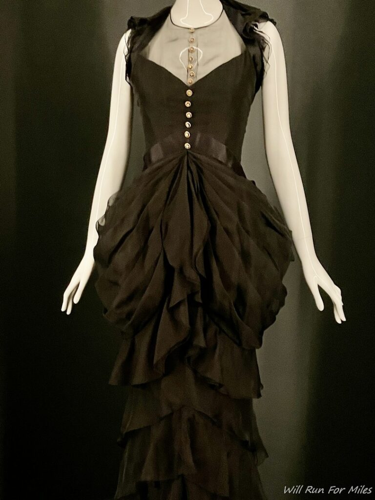 a mannequin wearing a black dress