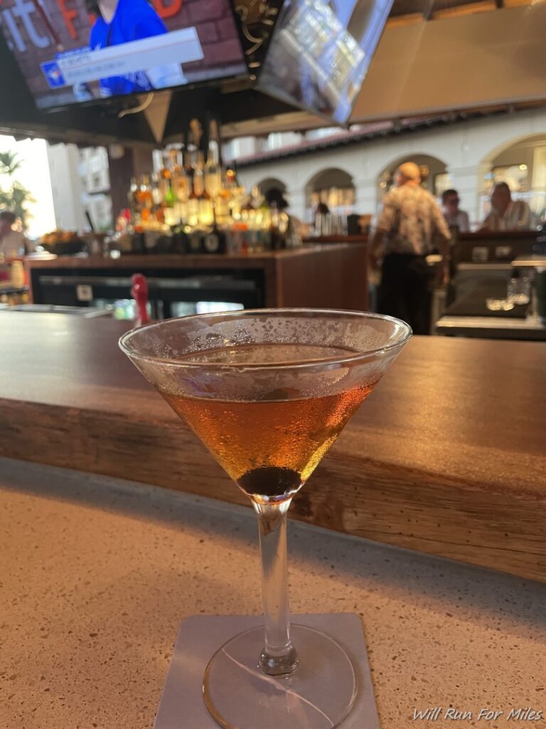 a martini glass with brown liquid in it