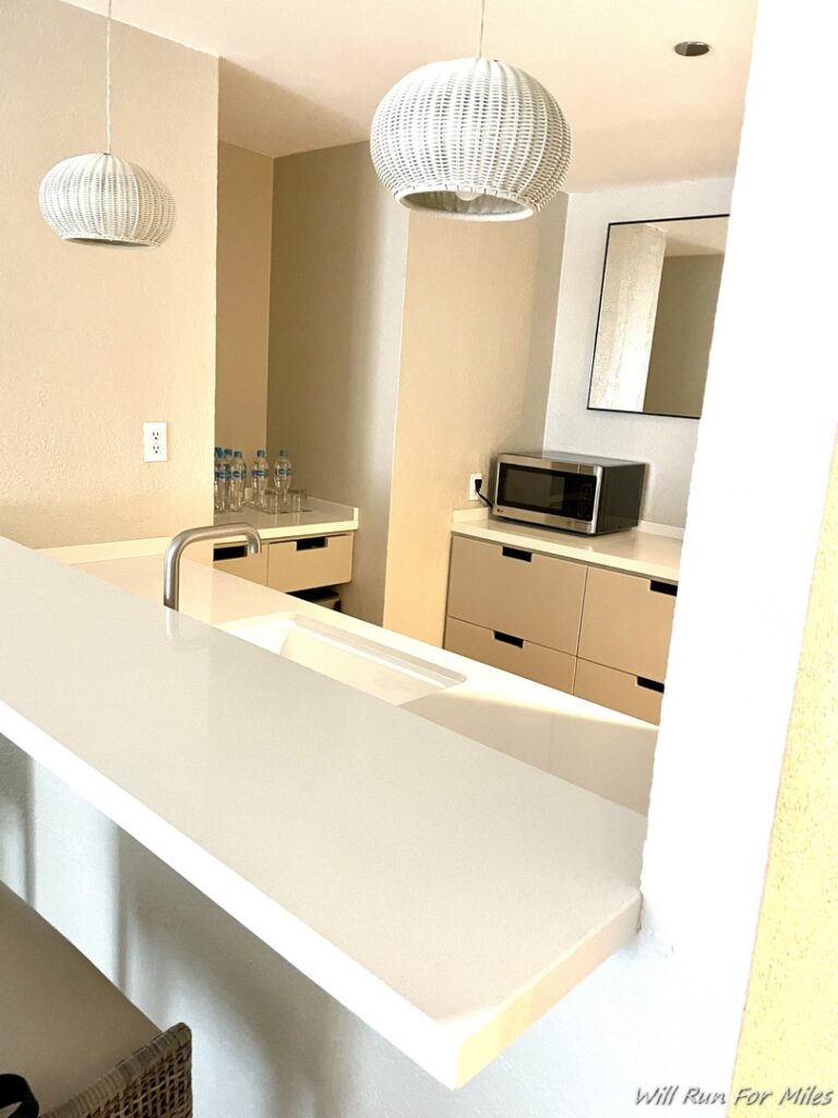 a kitchen with a white countertop and a microwave