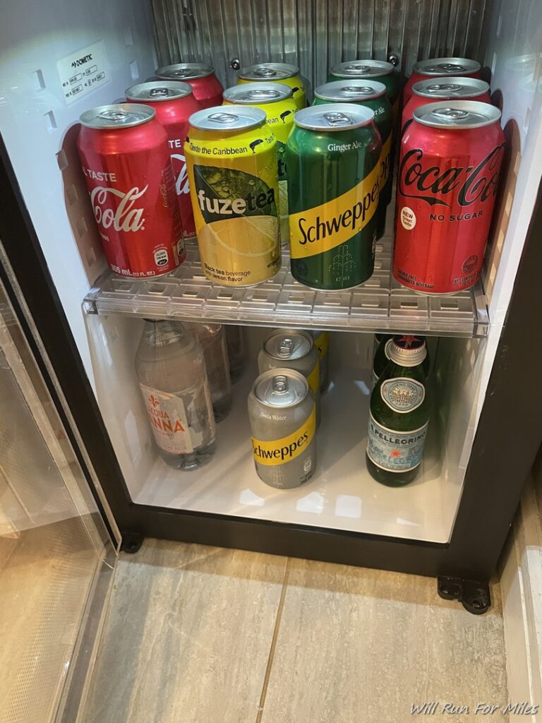 a refrigerator full of soda cans