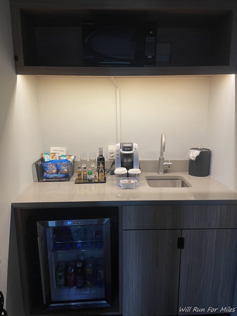 a small kitchen with a mini fridge and a coffee machine