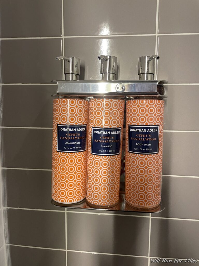 a group of orange bottles on a metal shelf