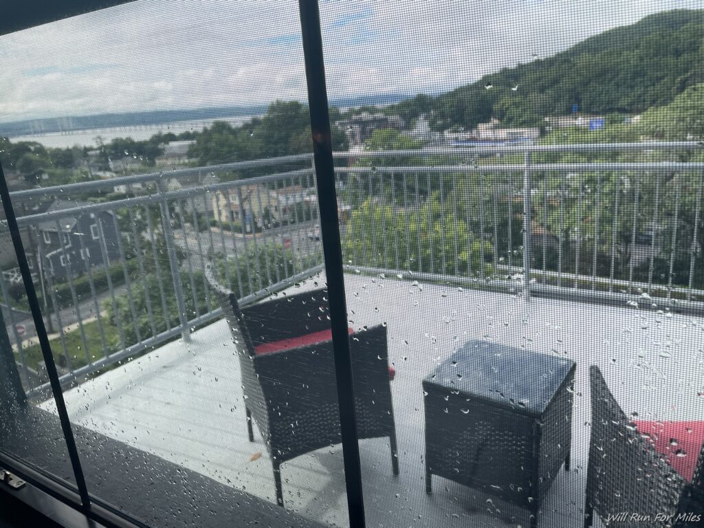 a patio with chairs and a table on a rainy day