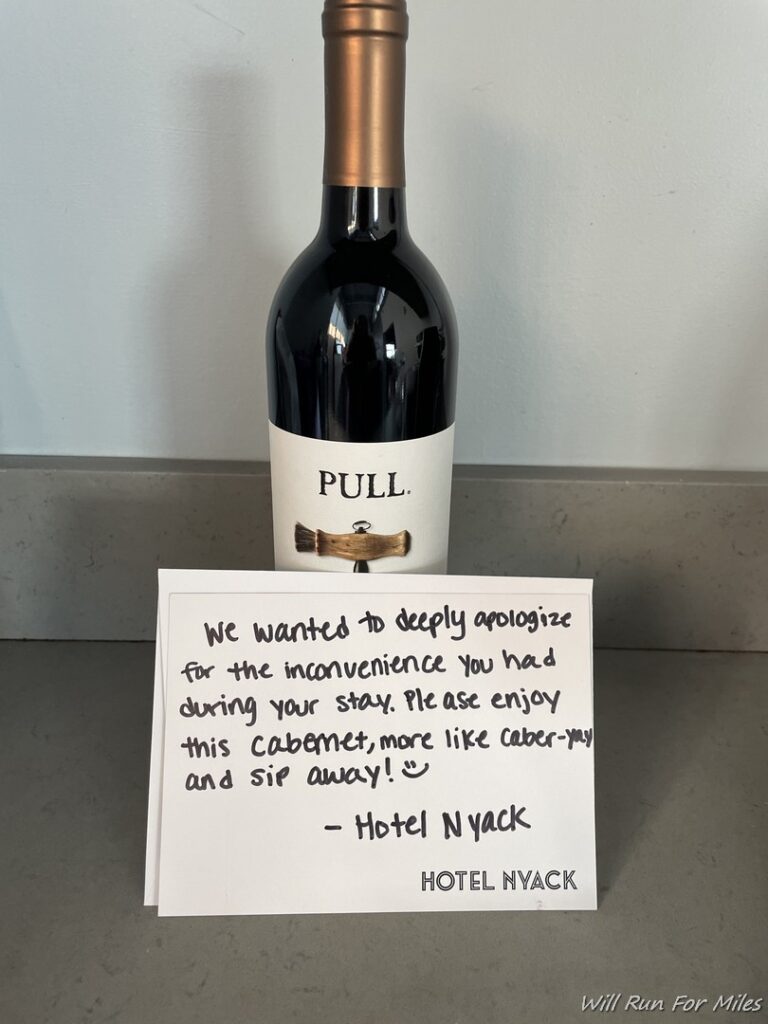 a bottle of wine with a note