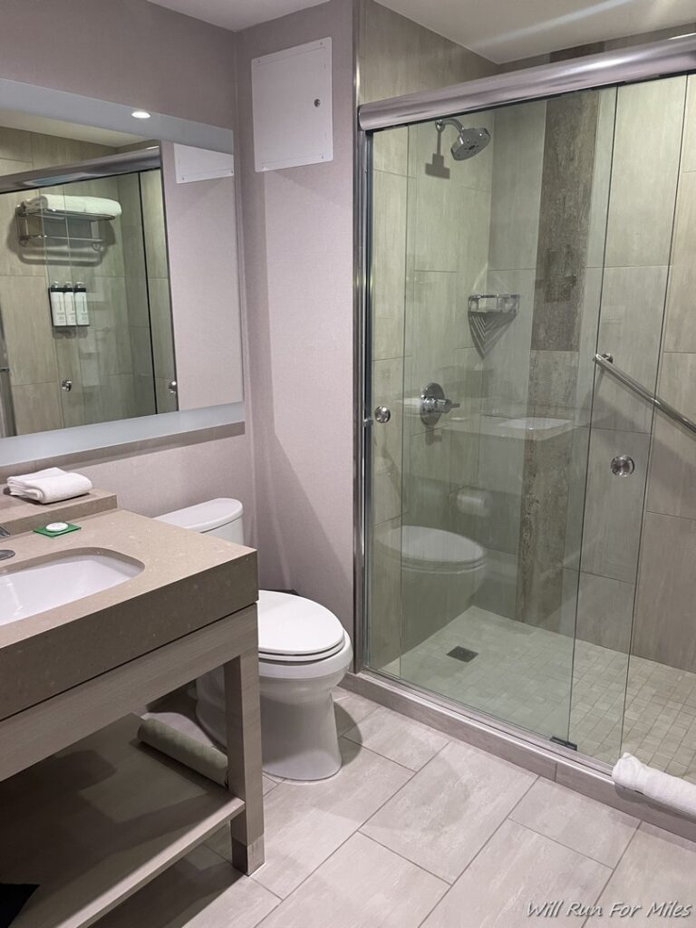 a bathroom with a glass shower and toilet