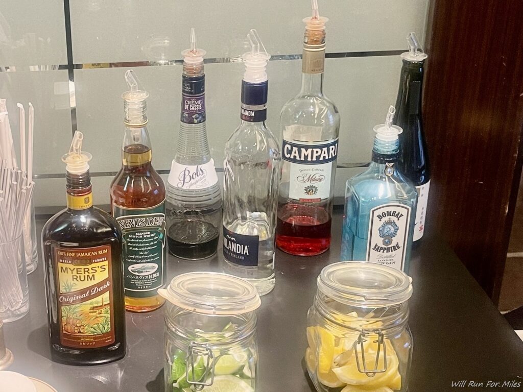 a group of bottles of liquor and lemons