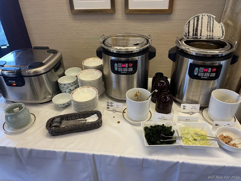 a table with crock pot and plates