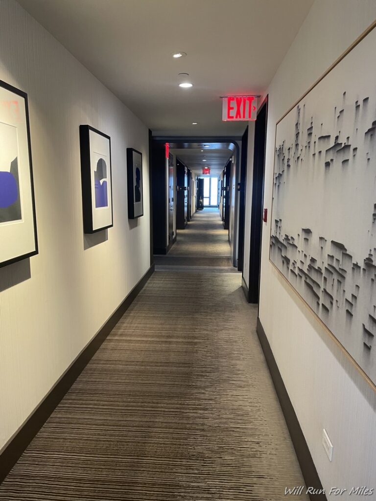 a hallway with art on the wall