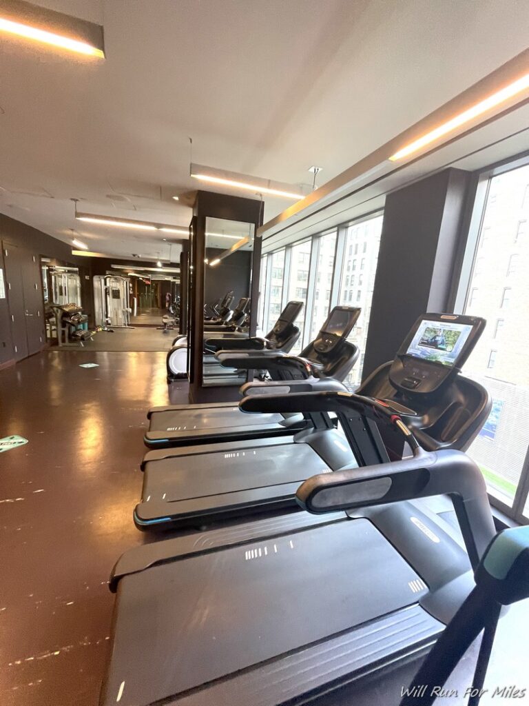 a room with treadmills and a large window