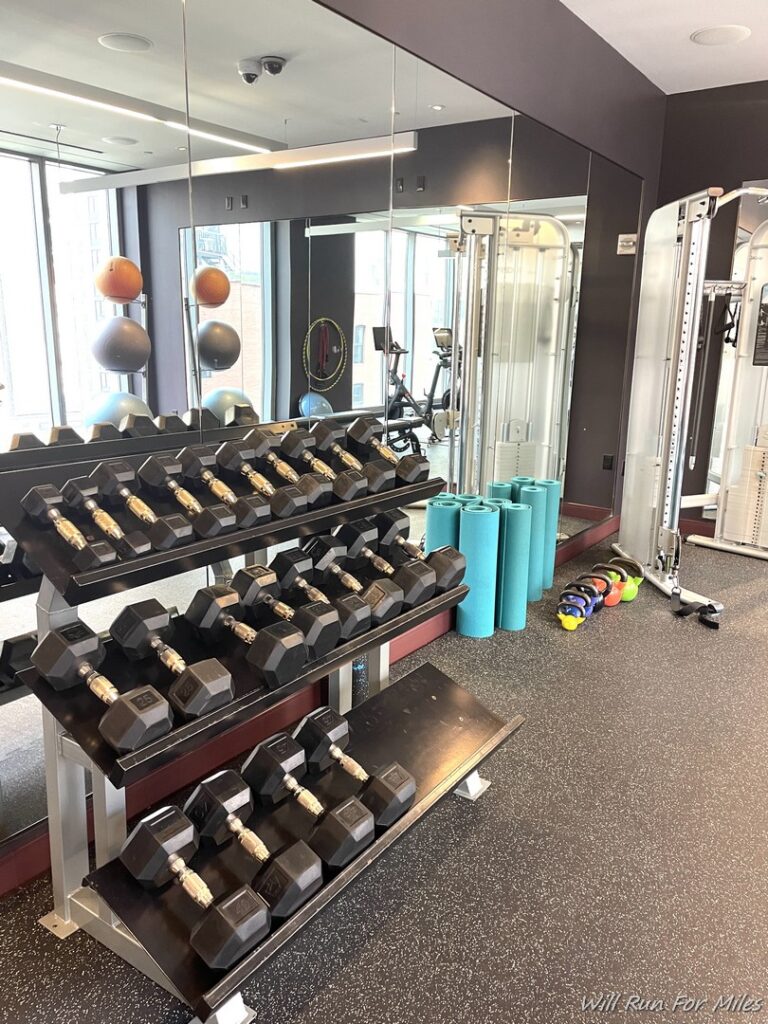 a room with a gym and exercise equipment