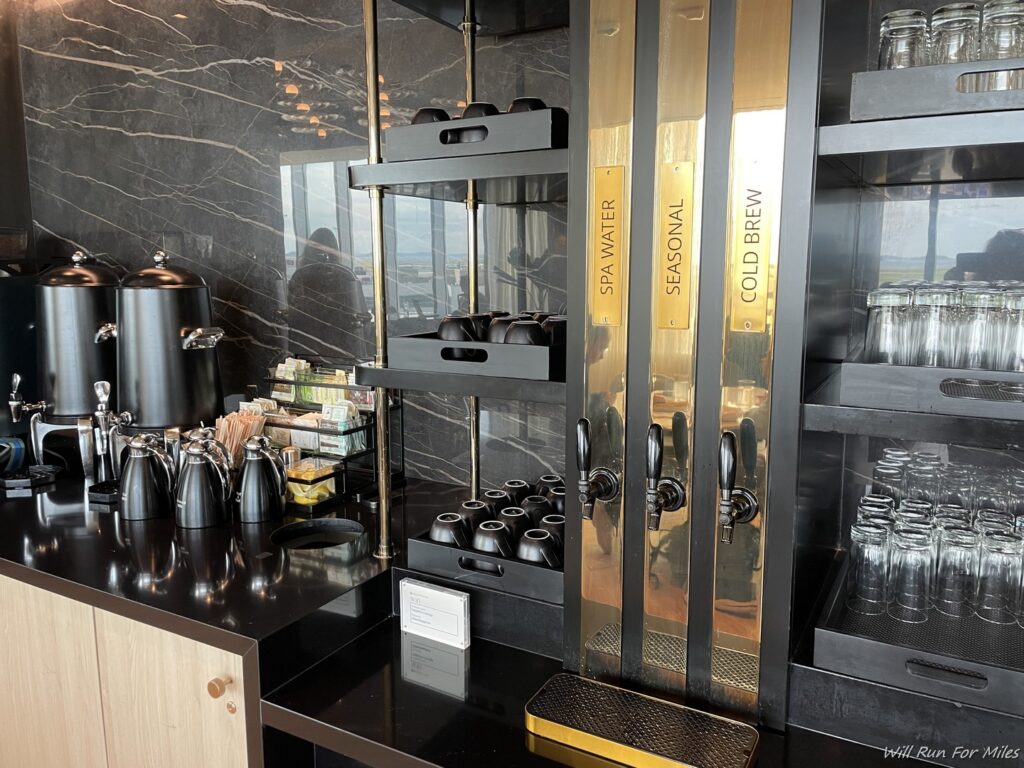 a black counter with black and gold shelves and black objects