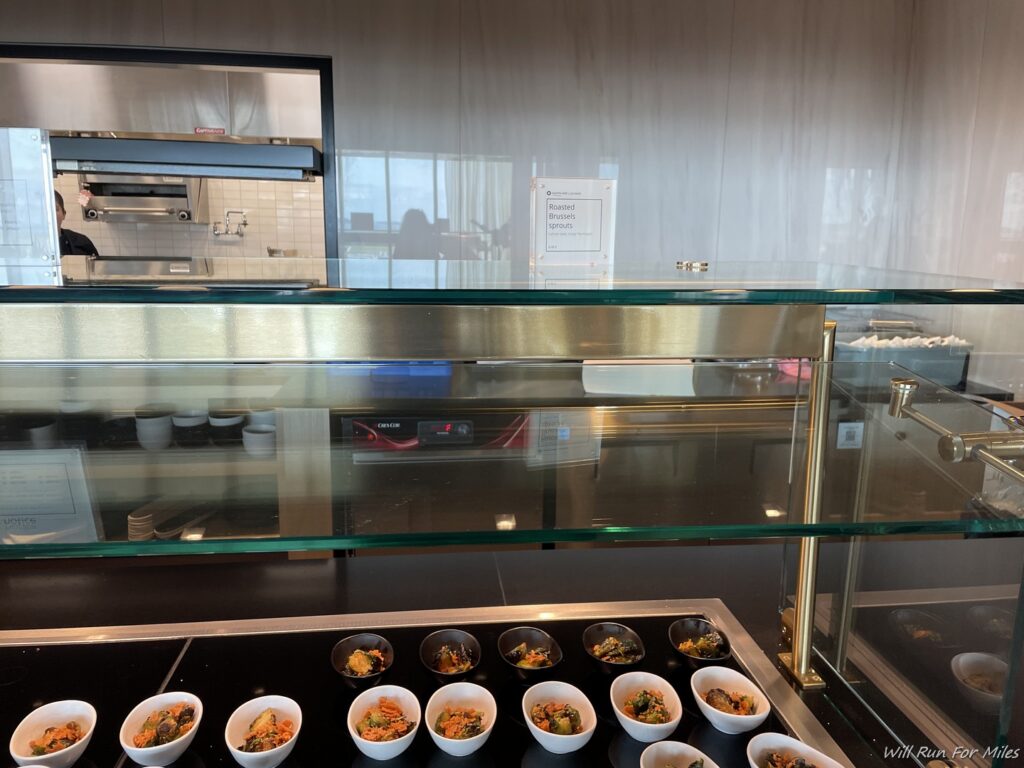 a glass display case with food in bowls
