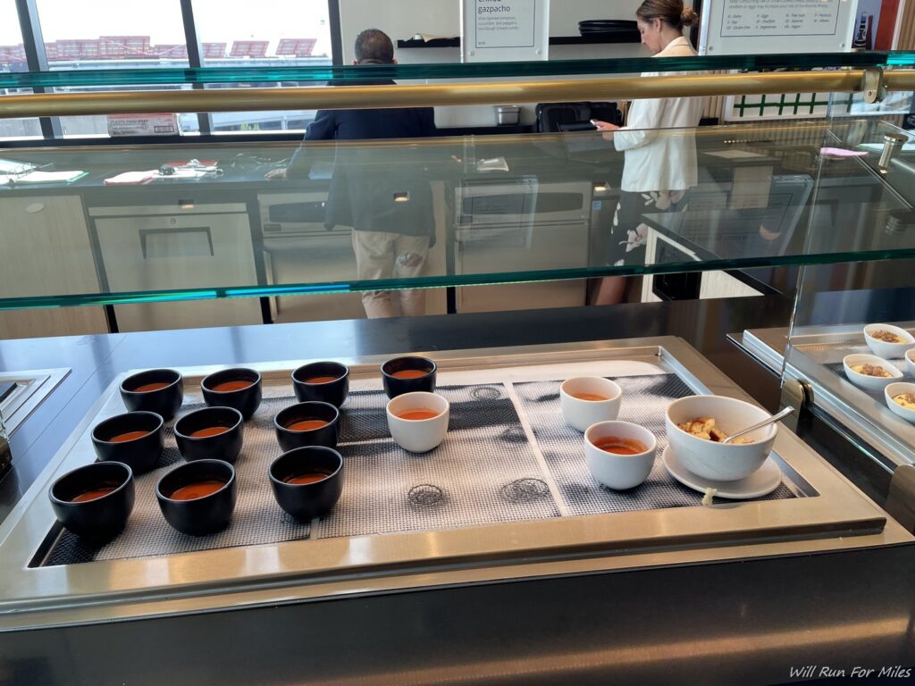 a group of bowls of soup on a counter