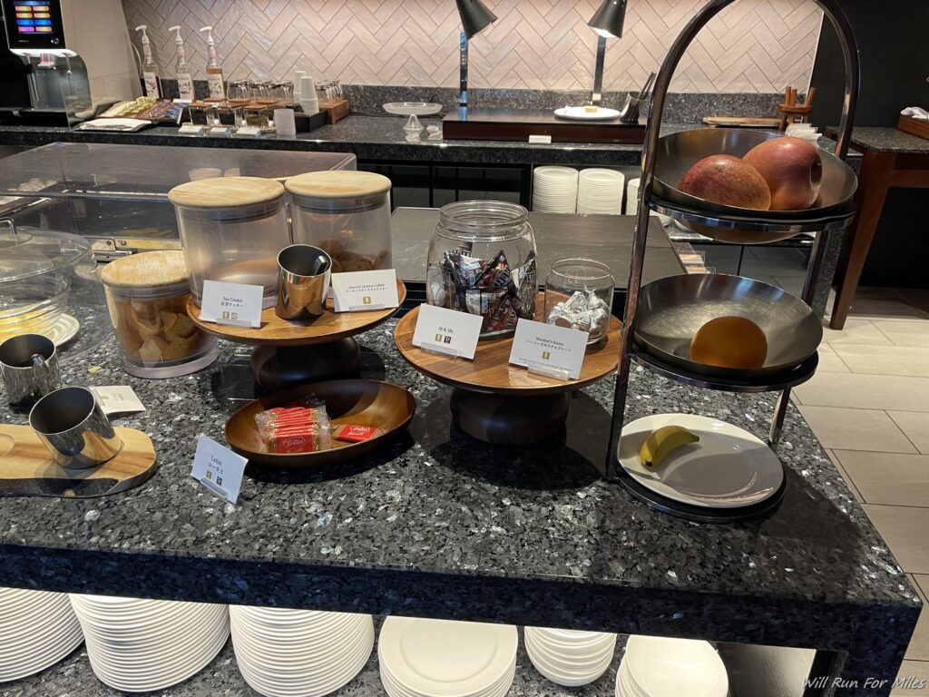 a counter with plates and bowls of food