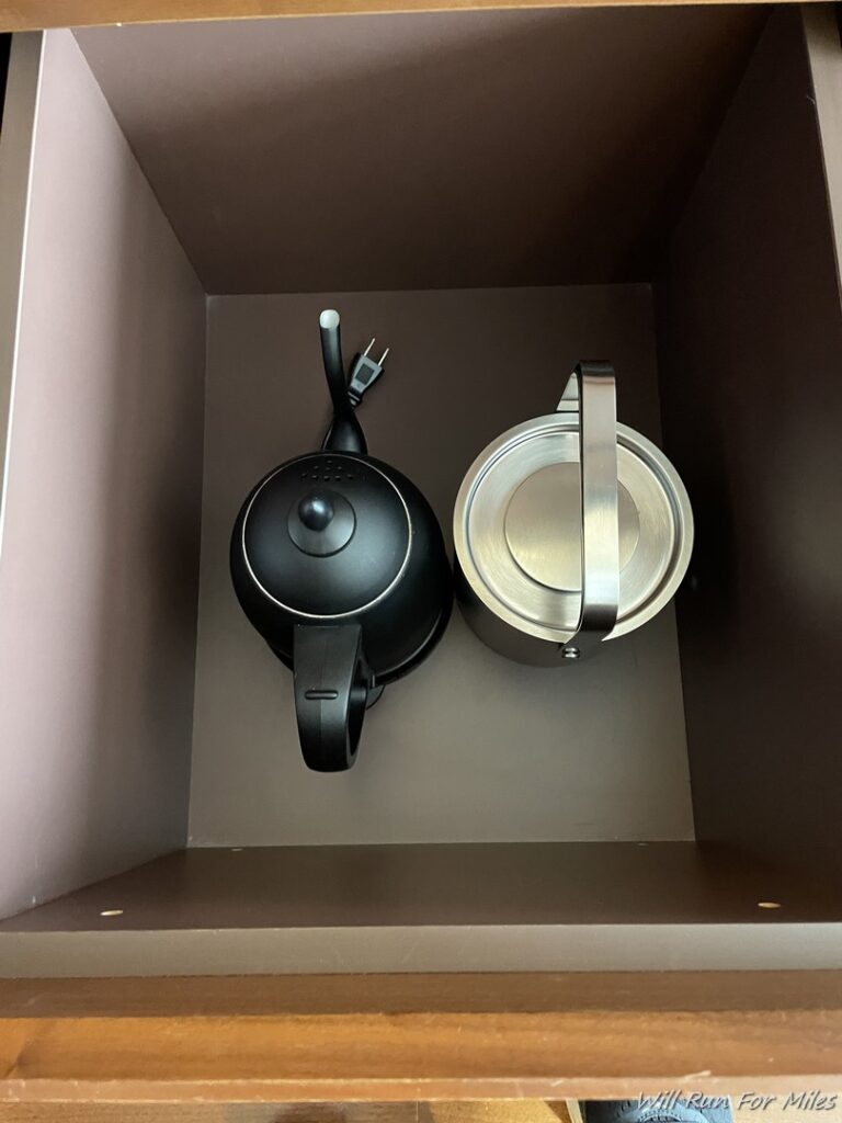 a teapot and a metal container in a box