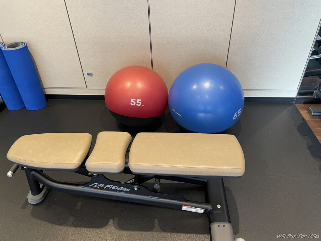 a bench with weights on the floor