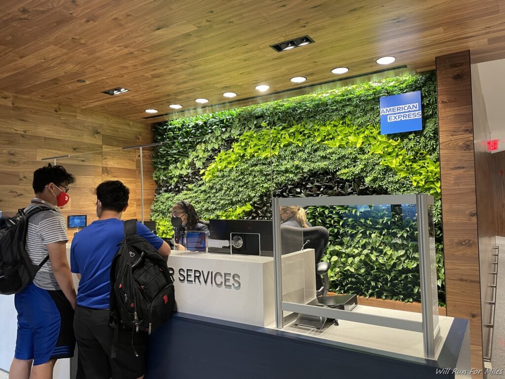 people standing in front of a green wall