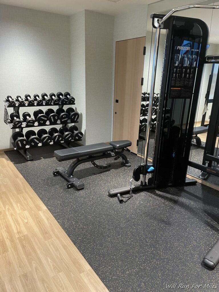 a gym with weights and a machine