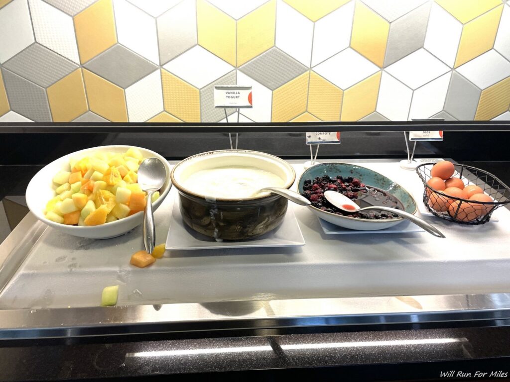 a bowl of fruit and a bowl of food on a counter