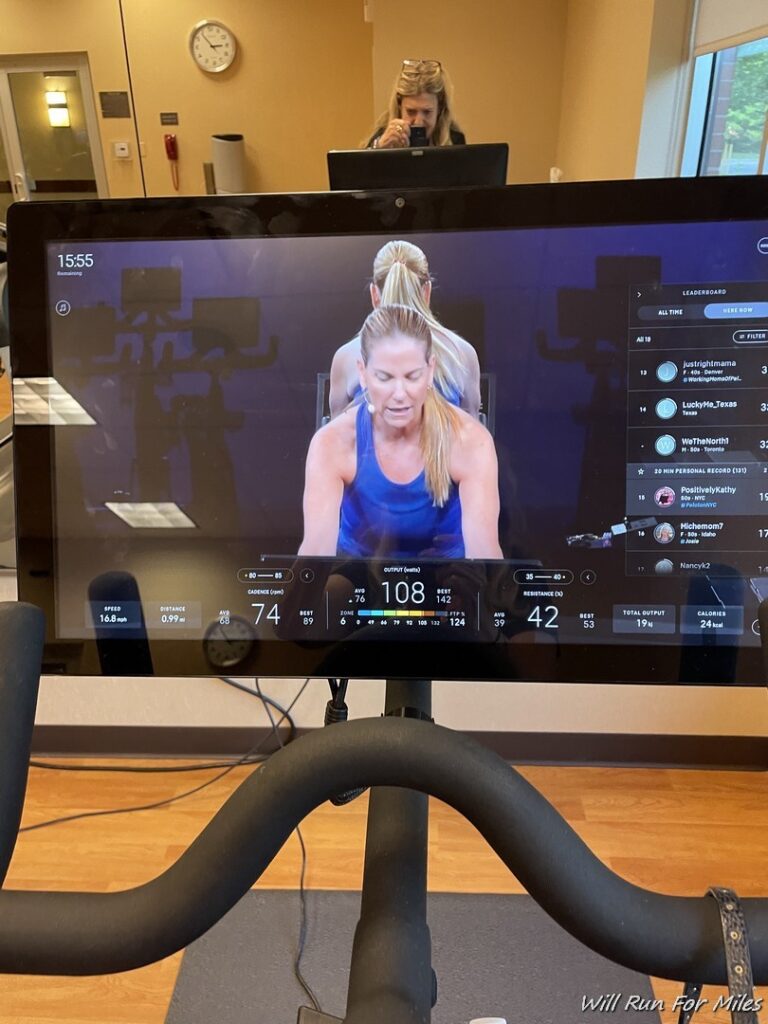 a screen showing a woman exercising on a treadmill