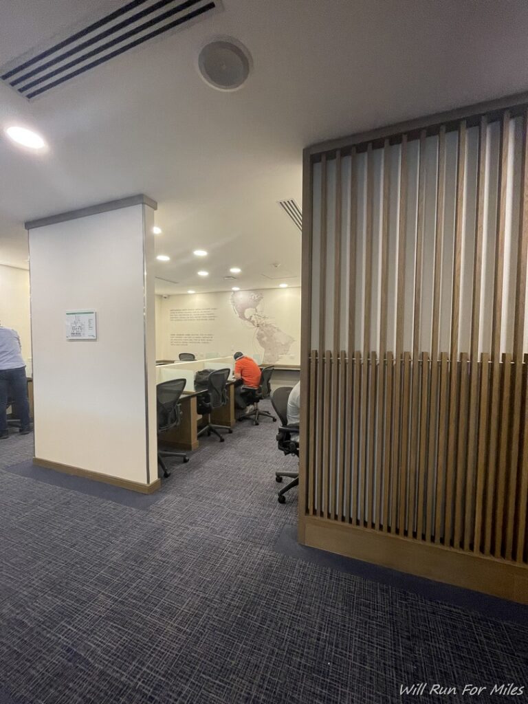 a room with a wall and a wall with a person sitting at a desk