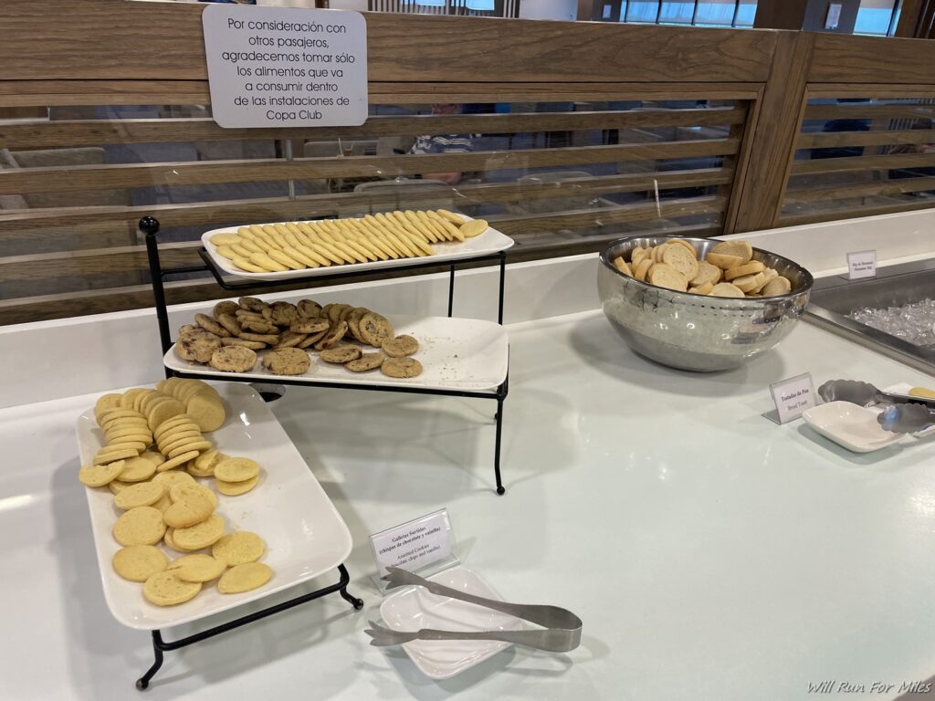a table with different types of cookies on plates
