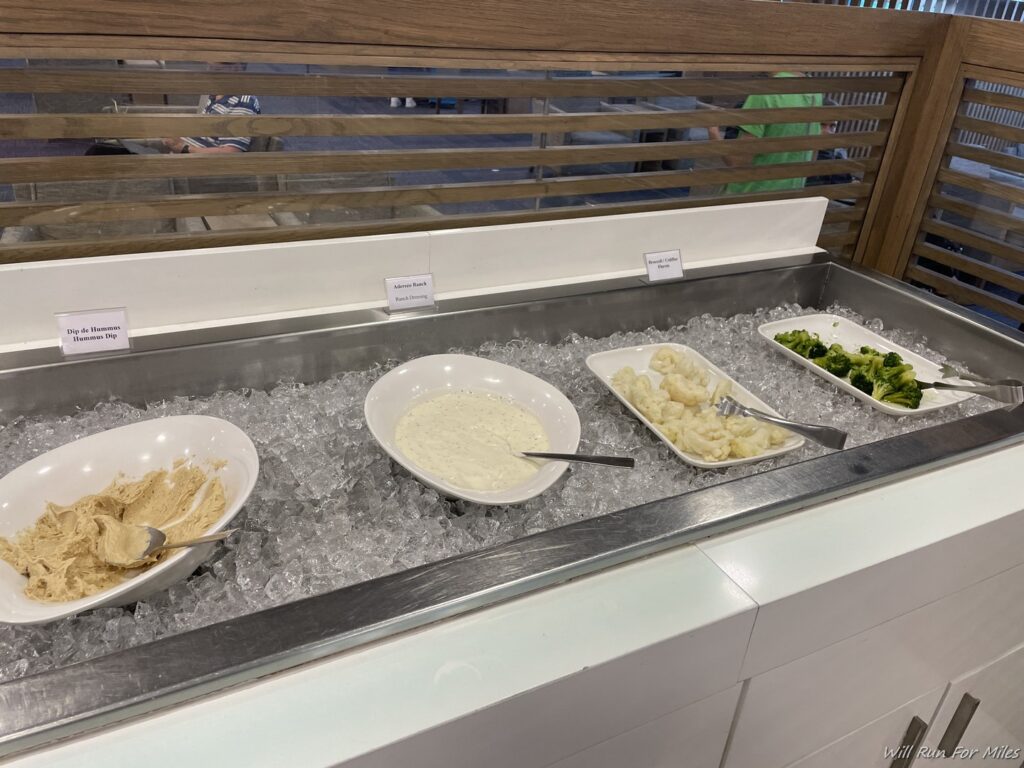 bowls of food on ice in a buffet