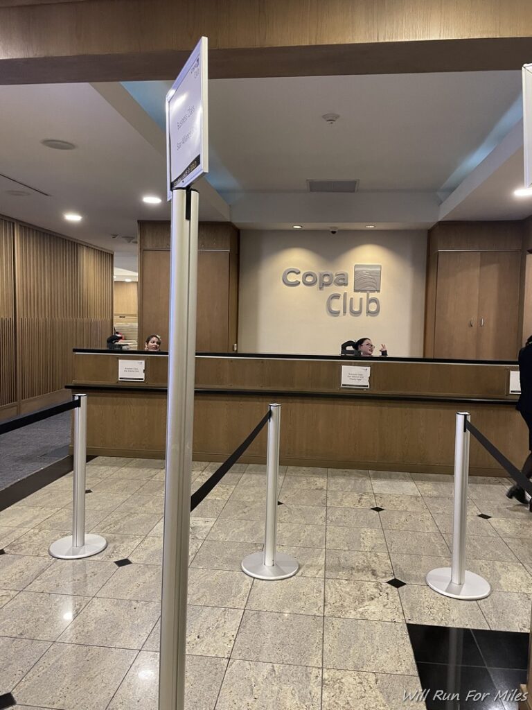 a group of people standing in front of a reception desk