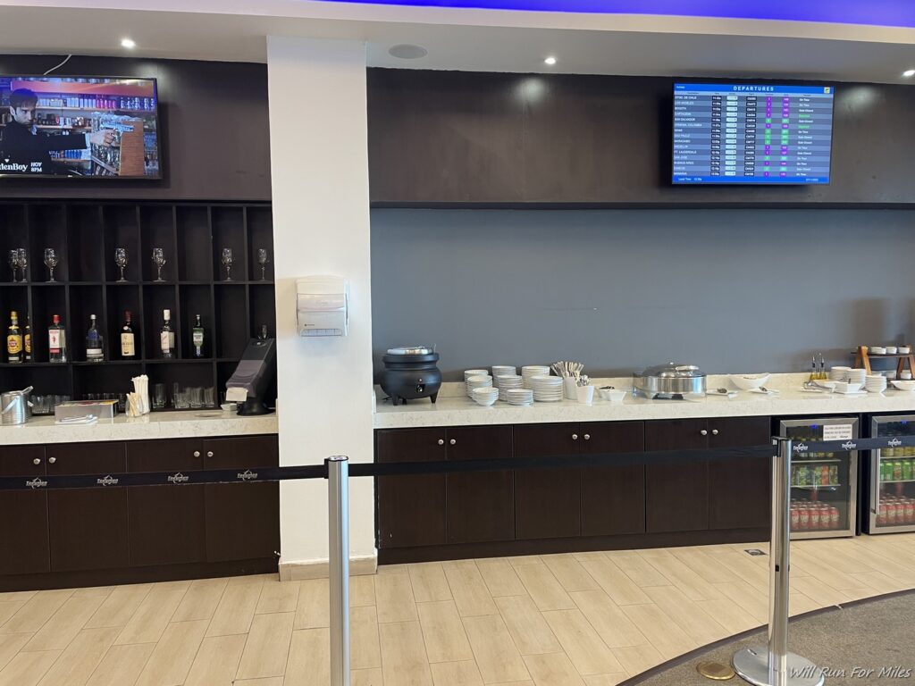 a buffet line with a screen on the wall