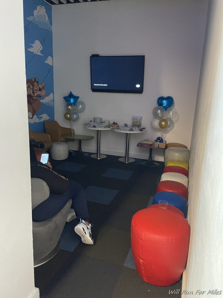 a room with a television and balloons