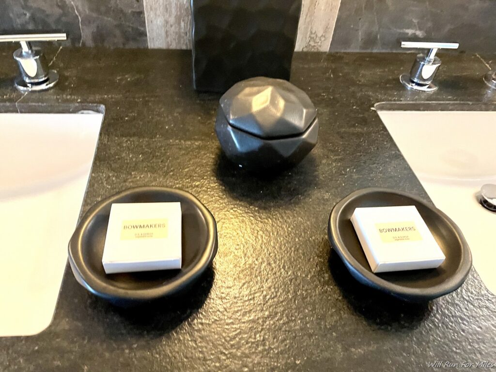 a black counter top with a black bowl and white boxes on it