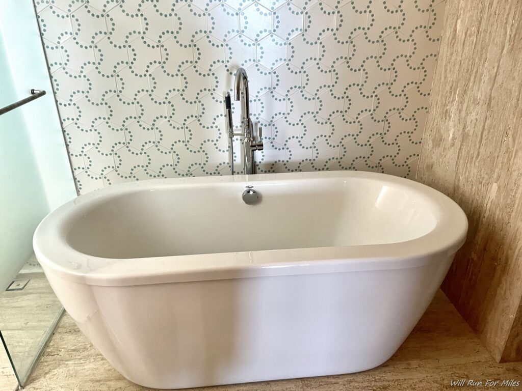 a white bathtub with a faucet
