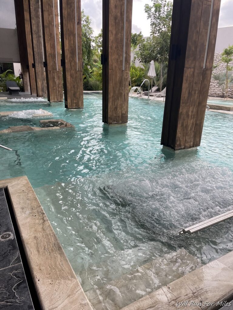 a pool with water and wooden pillars