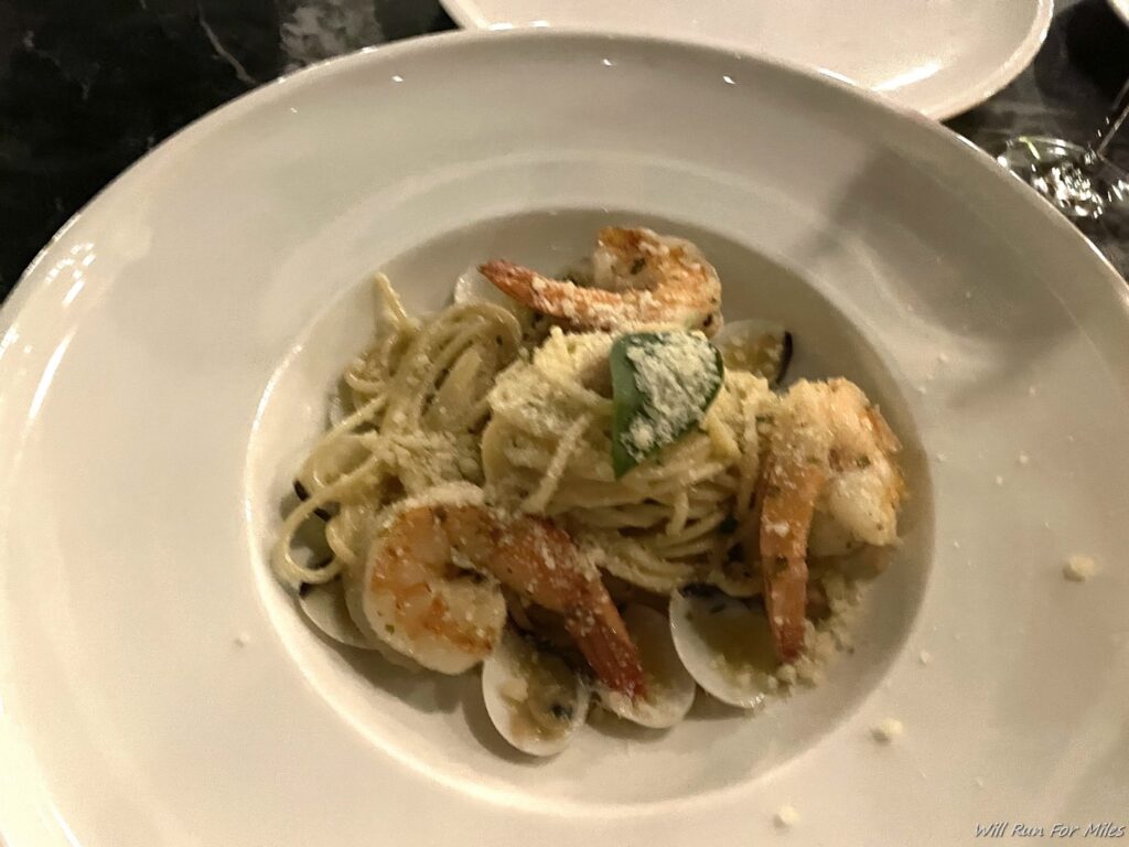 a plate of pasta with shrimp and clams