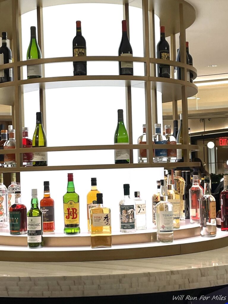a group of bottles of alcohol on a circular shelf