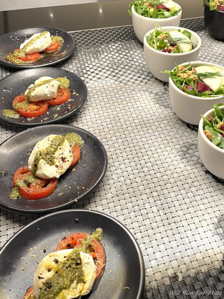 a row of plates of salads