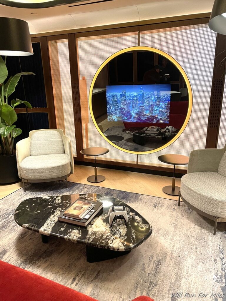 a room with a television and a large mirror