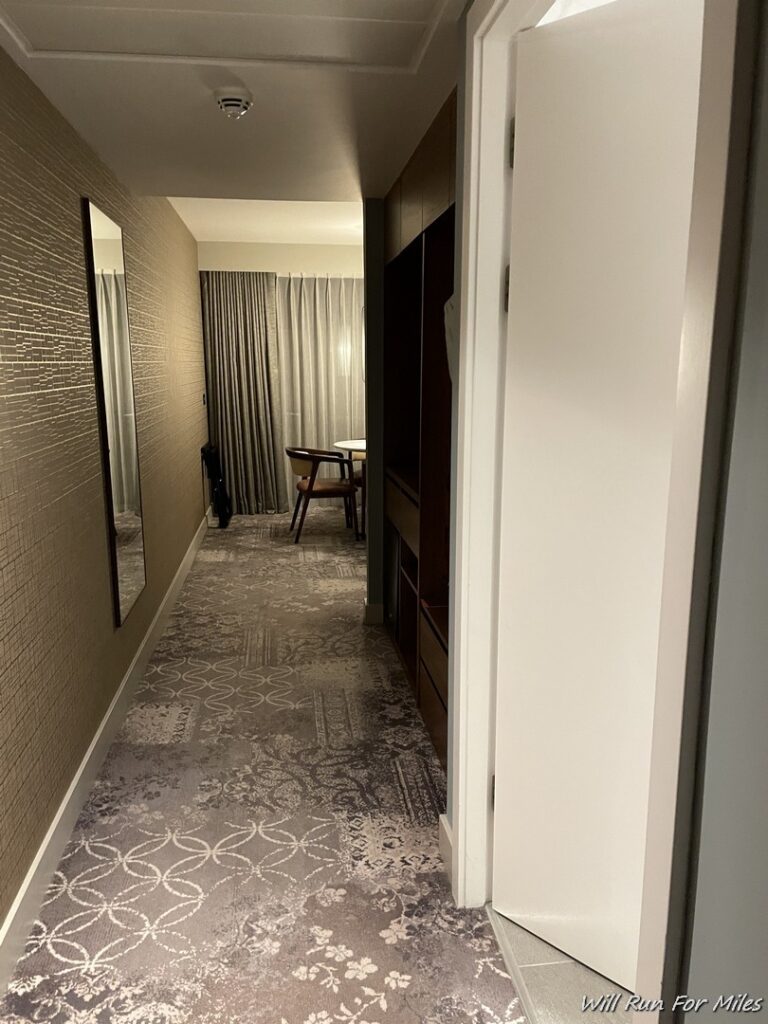a hallway with a mirror and a table