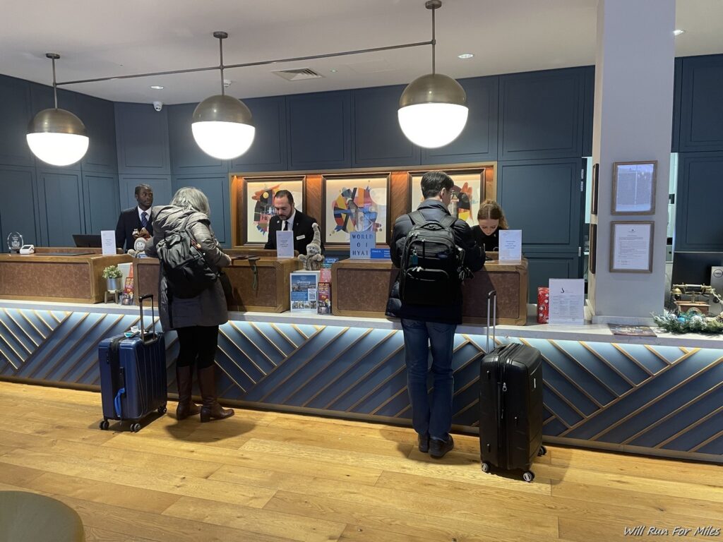 people standing at a reception desk