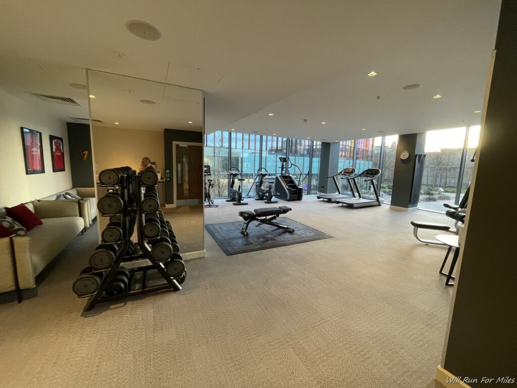 a room with exercise equipment and a couch