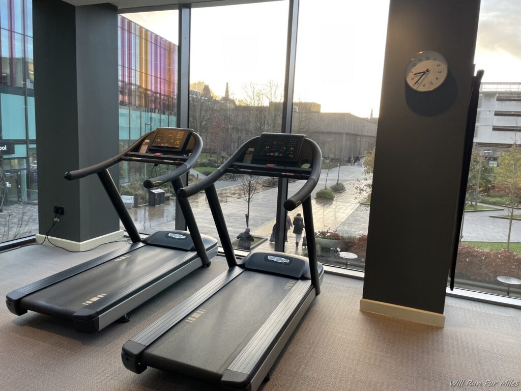 tread treadmills in a room with a clock