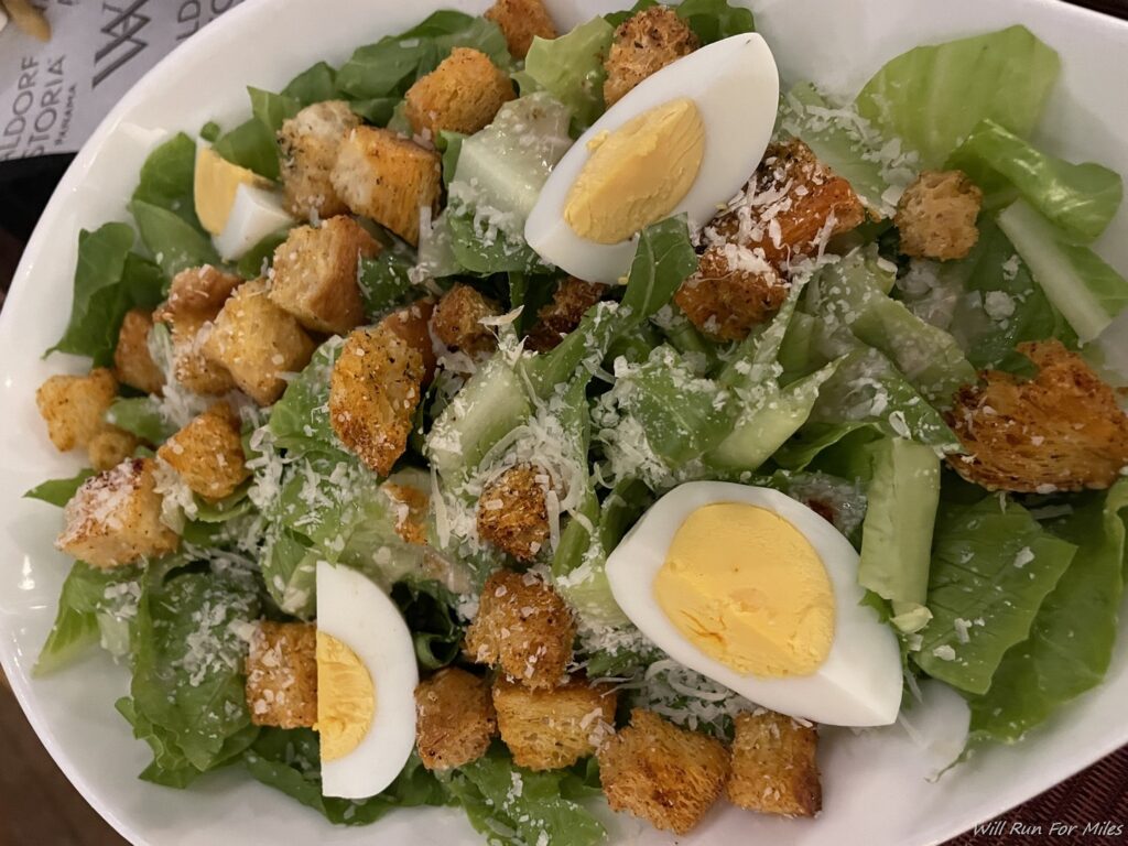 a salad with eggs and croutons on a plate