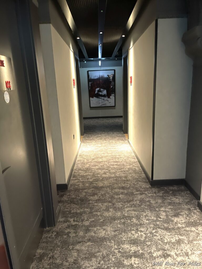 a hallway with a picture of a bear on the wall